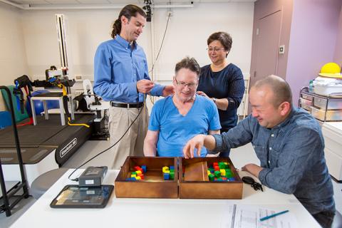 CNT Co-Director, Chet Moritz (left), and CNT-funded graduate students, Fatma Inanici and Soshi Samejima, work on motor skill tasks with study participant Joe Beatty (center) in the UW AMP Lab. These tasks help test the effectiveness of transcutaneous spinal stimulation when combined with physical therapy. CNT Co-Director, Chet Moritz (left), and CNT-funded graduate students, Fatma Inanici and Soshi Samejima, work on motor skill tasks with study participant Joe Beatty (center) in the UW AMP Lab. These tasks help test the effectiveness of transcutaneous spinal stimulation when combined with physical therapy.